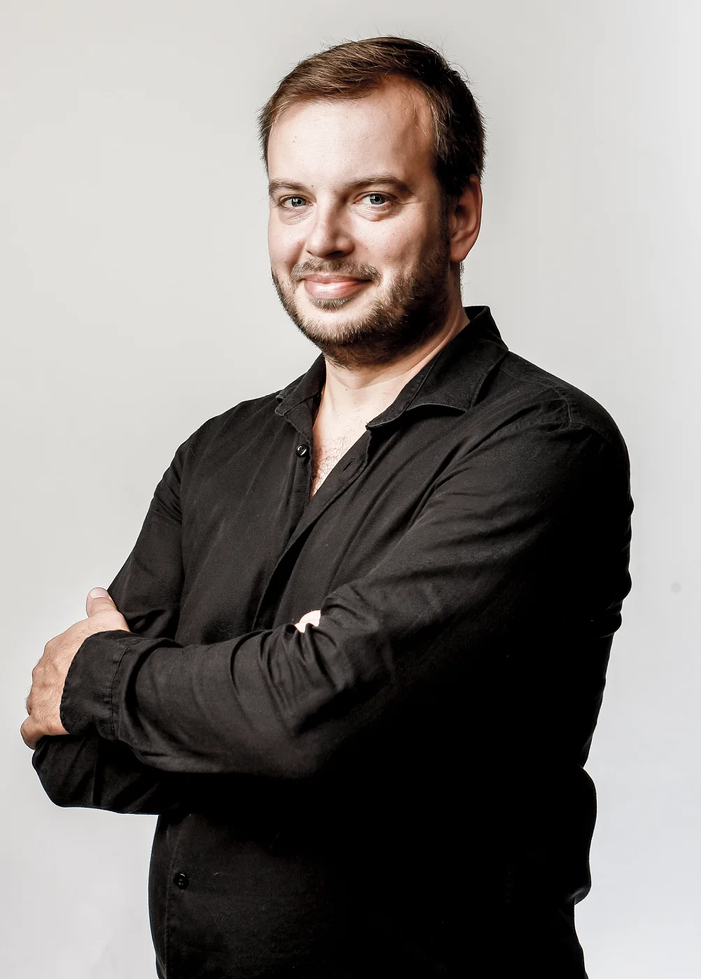 Jiří Kabát smiling with arms crossed